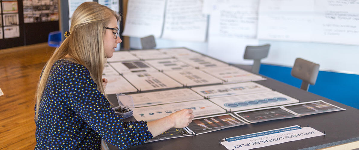 A designer puts together images to benchmark for product development