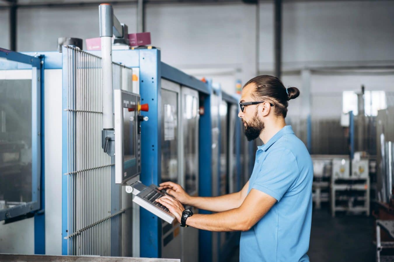 Engineer working at a control panel in a manufacturing plant
