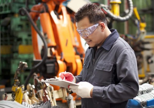 Engineer looking at notes in manufacturing space