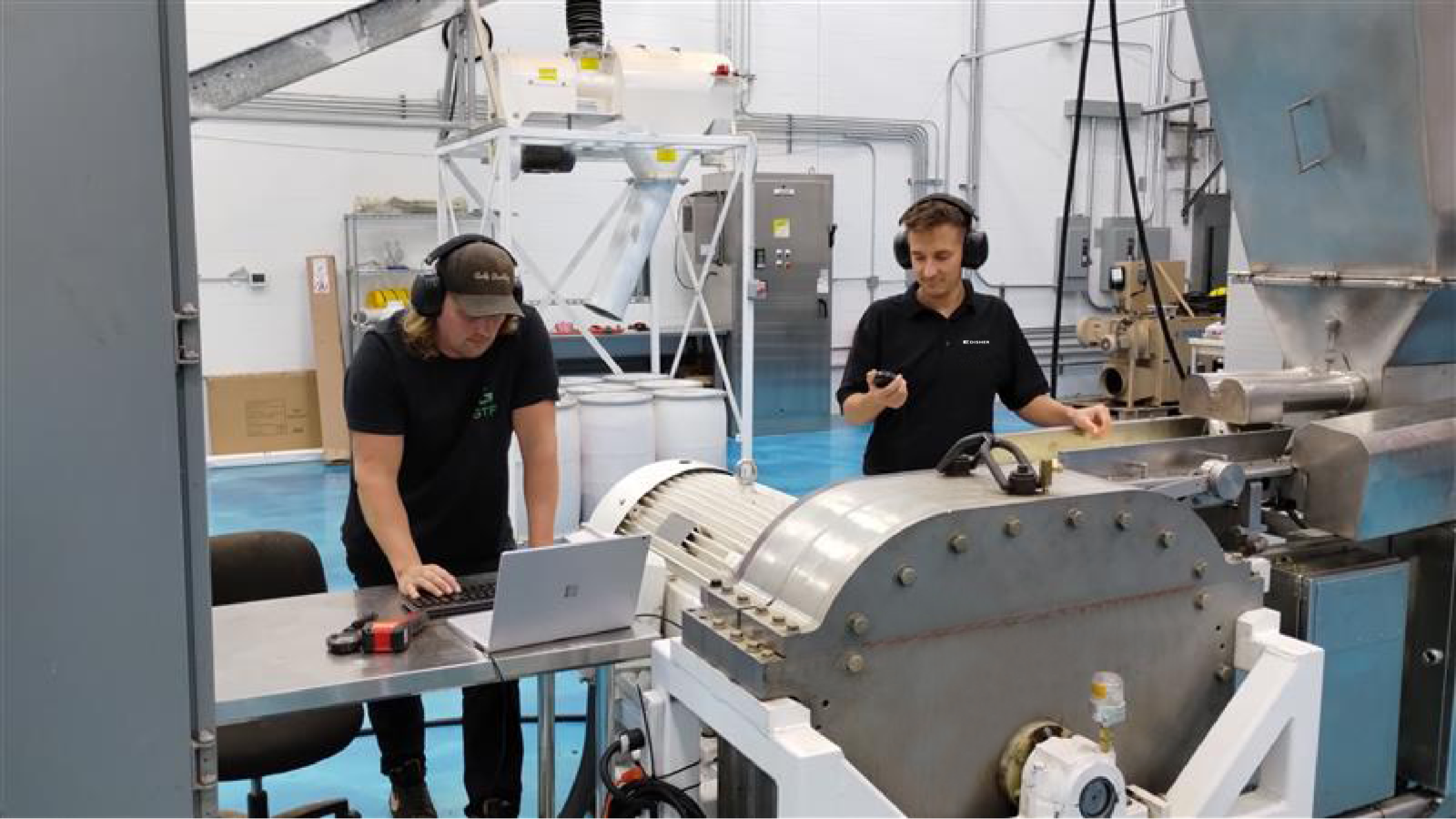 Two engineers working on food processing machine