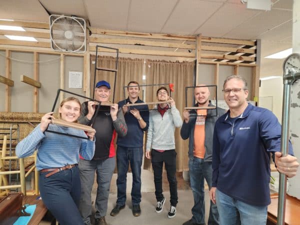 volunteers posing with picture frames