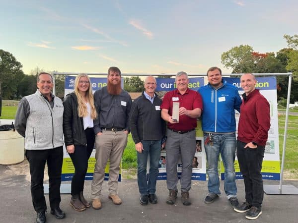 A group of DISHER employees accepting a habit for humanity award