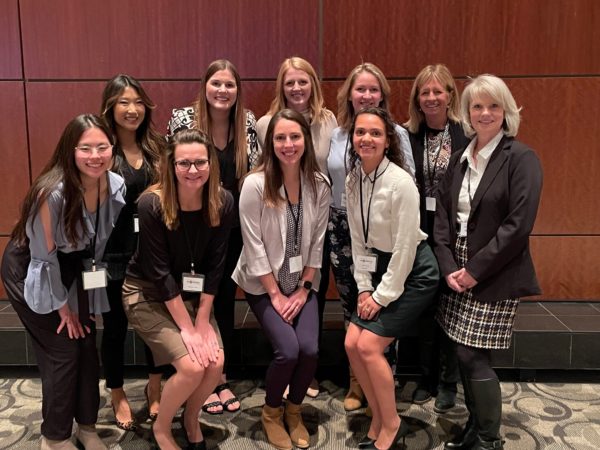 A group of DISHER women smiling at an event