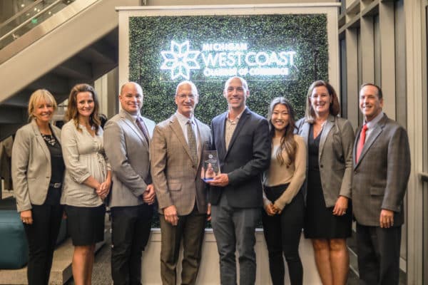 A group of DISHER leaders posing with the West Michigan Impact Award