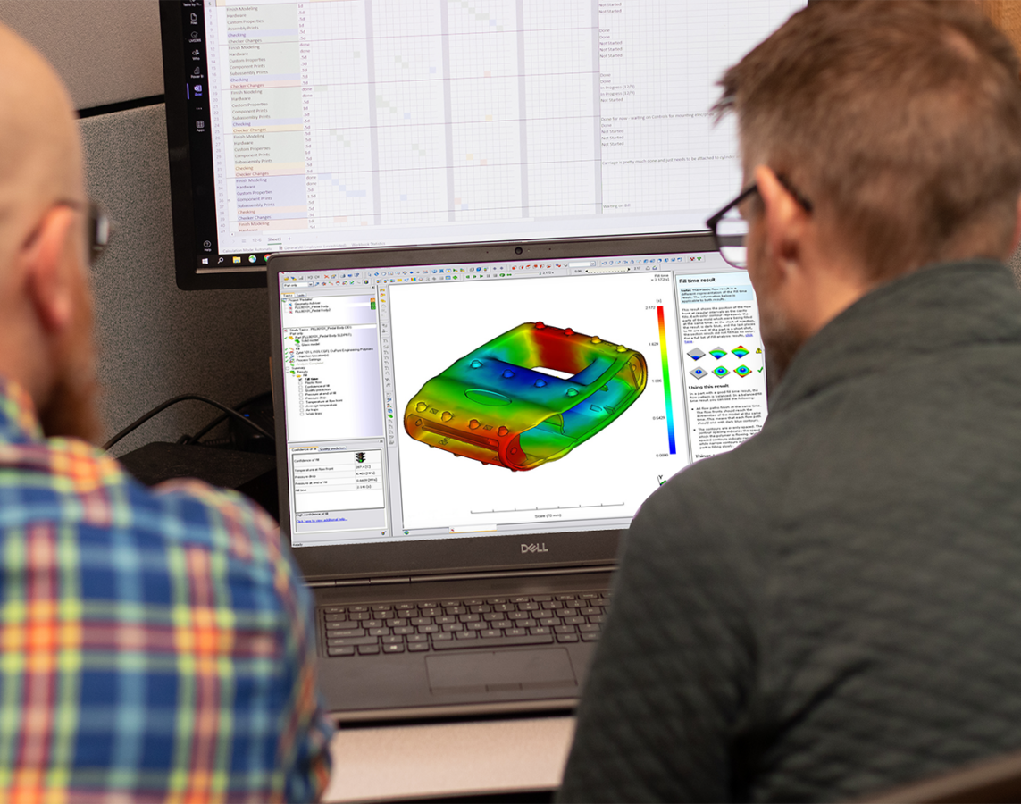 Two engineers looking at a mold flow analysis